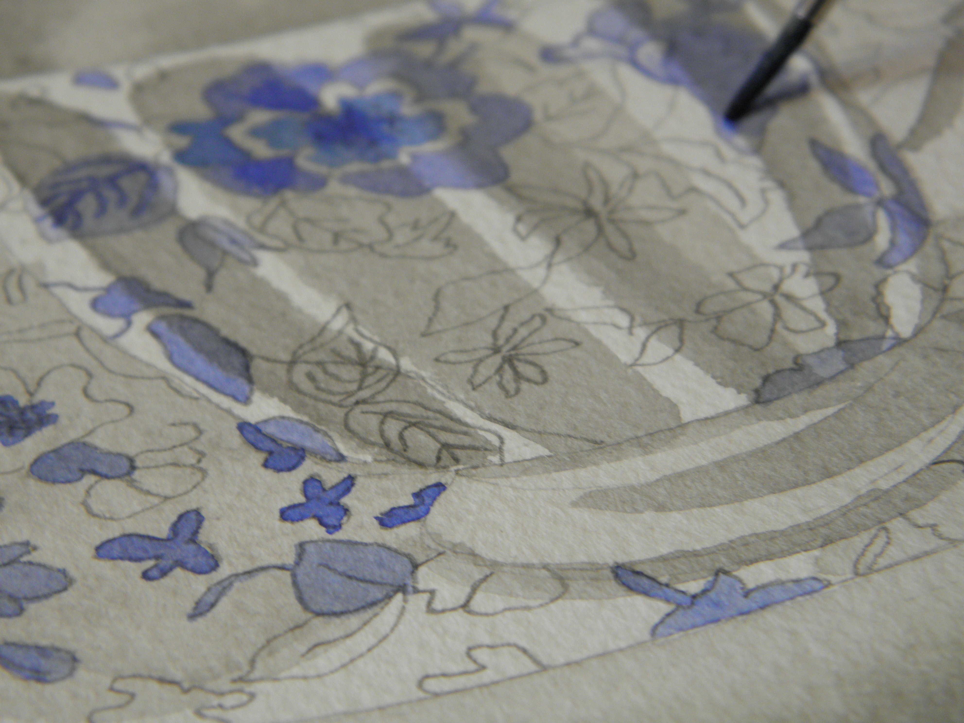 blue_white_floral_teacup_being_painted