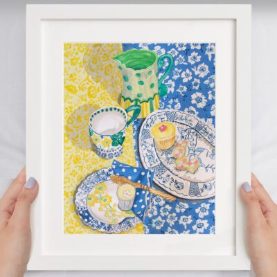Tea Table an original painting by Claire Leggett. Two hands holding a mocked up image of Tea Table - an original painting by Claire Leggett